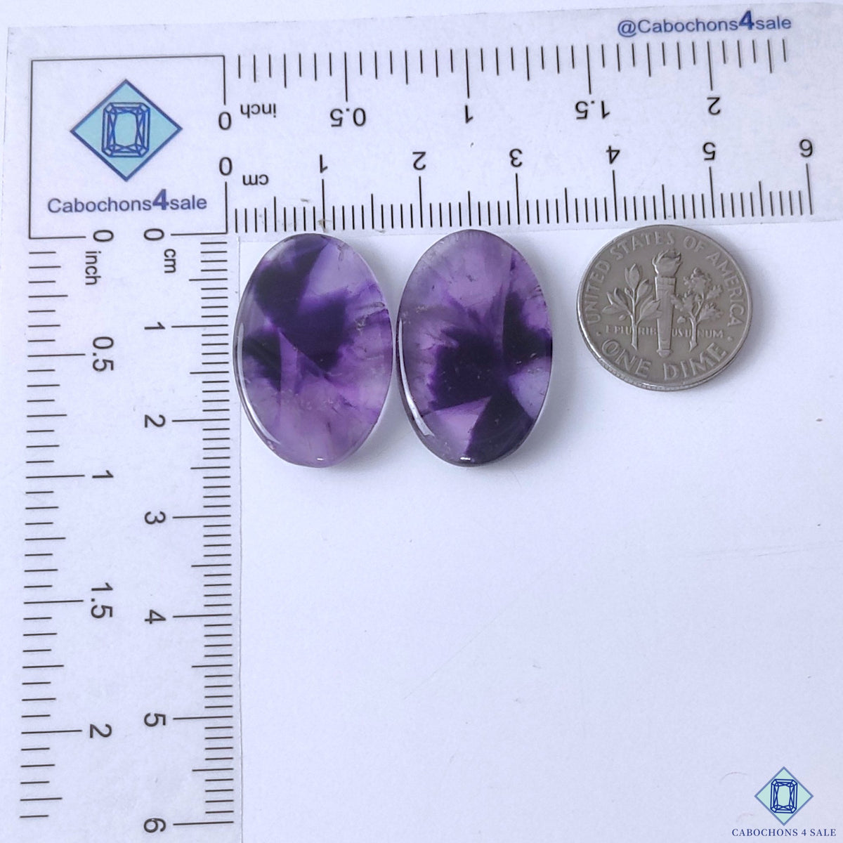 cabochons4sale, purple chevron amethyst oval gemstone cabochons featuring layered white quartz bands, rich violet tones and smooth polished texture held between fingers