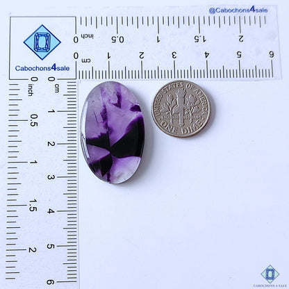cabochons4sale, natural purple trapiche amethyst oval cabochons displaying geometric internal divisions, rich violet tones and distinctive quartz texture held between fingers