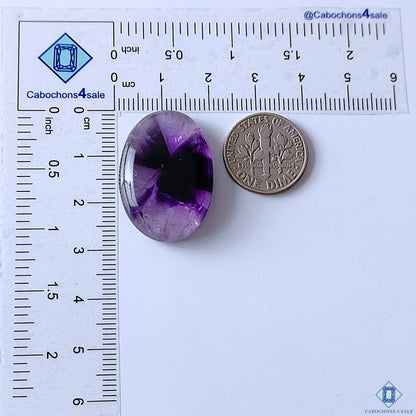 cabochons4sale, purple trapiche amethyst oval cabochons showcasing unique geometric formations, violet color depth and natural quartz inclusions held between fingers