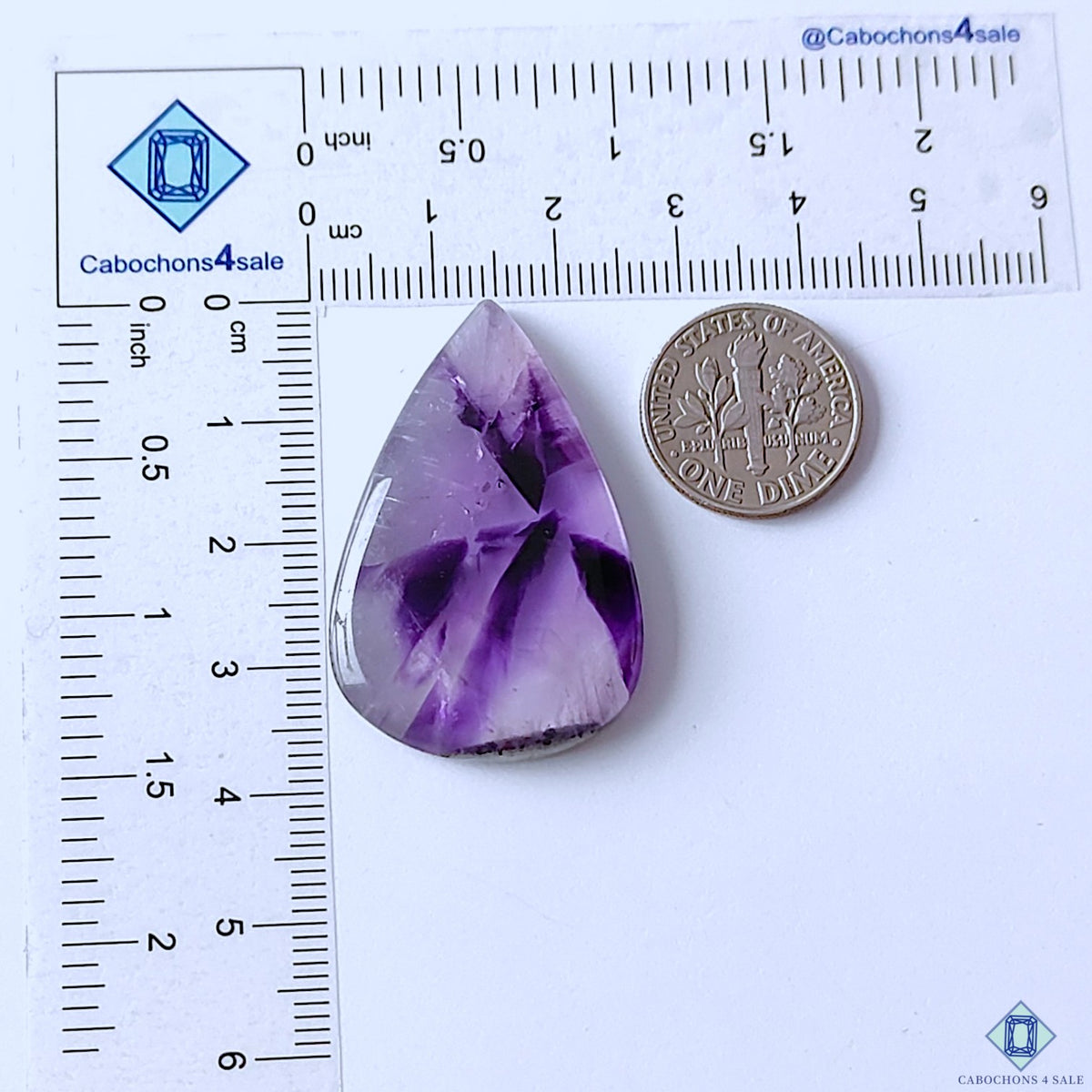 cabochons4sale, purple trapiche amethyst pear cabochons featuring striking radial formations, contrasting mineral sections and unique natural quartz texture held between fingers