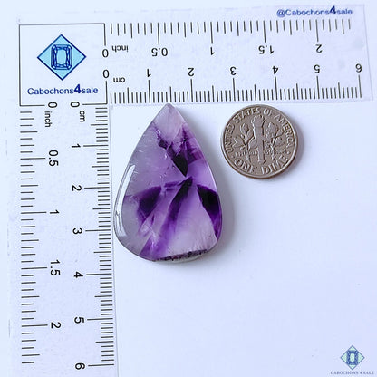 cabochons4sale, purple trapiche amethyst pear cabochons featuring striking radial formations, contrasting mineral sections and unique natural quartz texture held between fingers