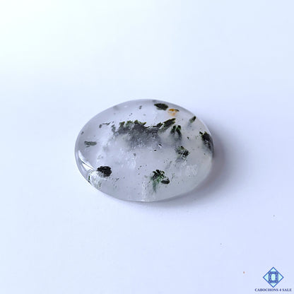 cabochons4sale, polished black dot quartz round cabochons showcasing contrasting black inclusions on white quartz, eye-catching dotted formations and distinctive natural stone character held between fingers