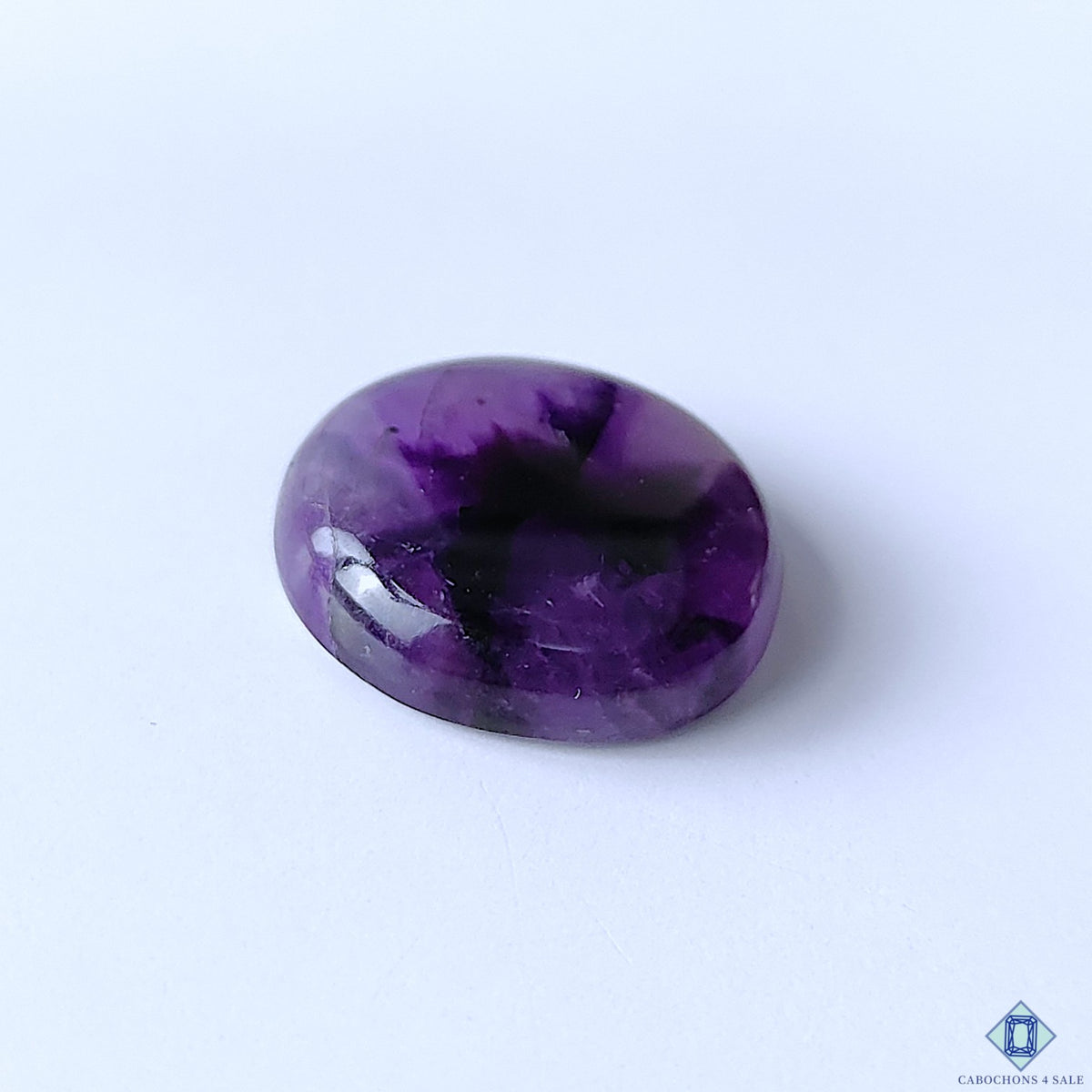 cabochons4sale, round natural purple amethyst cabochons featuring elegant violet coloration, translucent-looking crystalline texture and a refined polished finish held between fingers