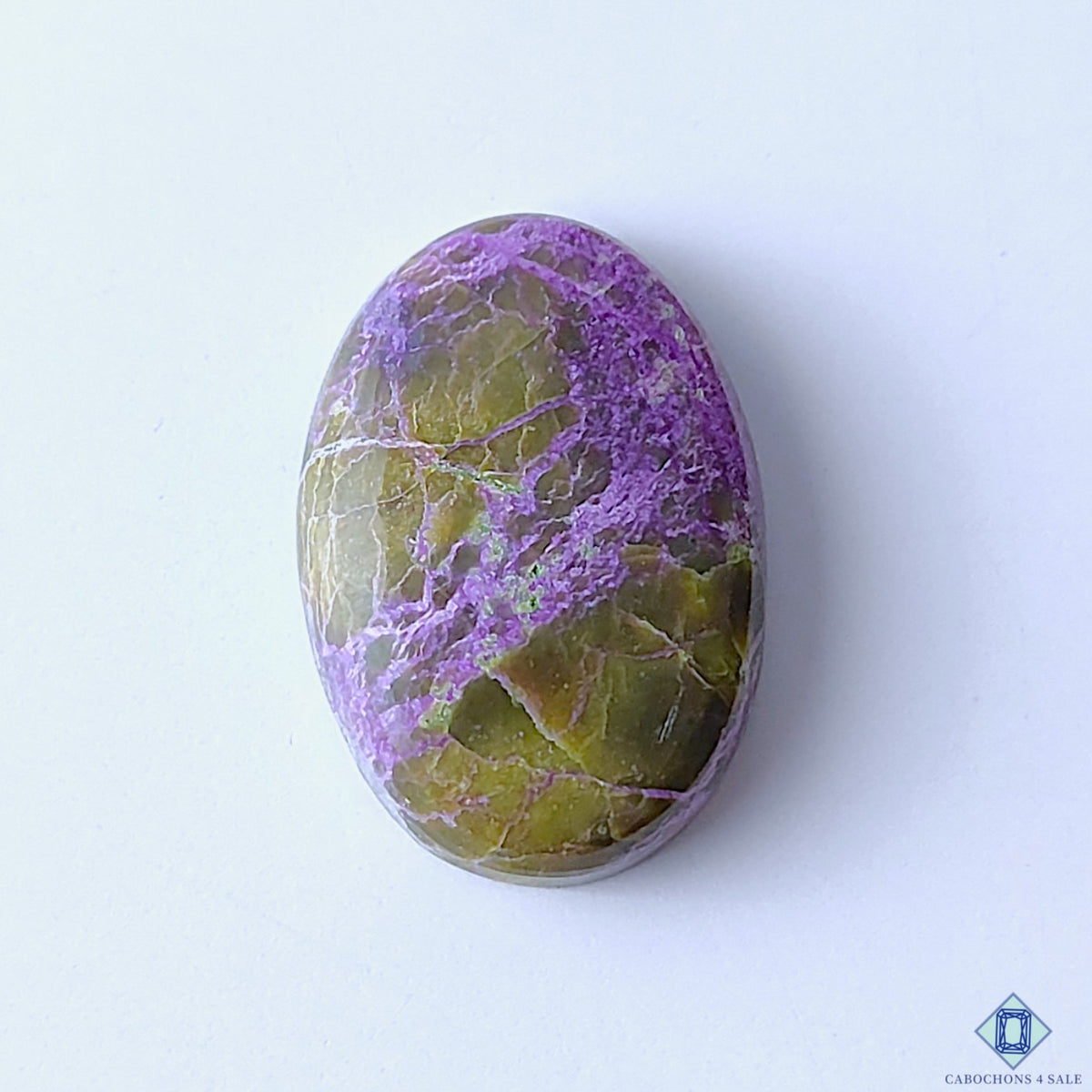 cabochons4sale, natural stichtite oval cabochons in purple and green shades with soft color blending, organic mineral patterns and polished surfaces held between fingers