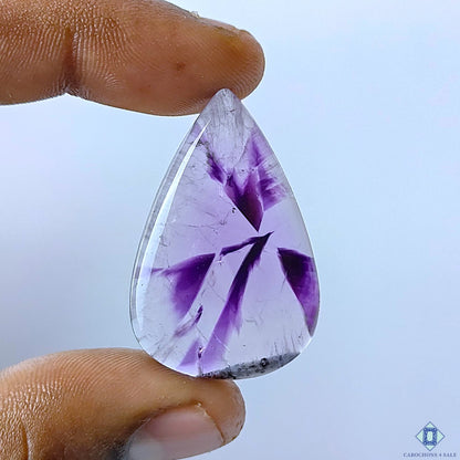 cabochons4sale, natural trapiche amethyst pear cabochons in rich purple tones with distinctive geometric zoning, crystalline patterns and polished surfaces held between fingers